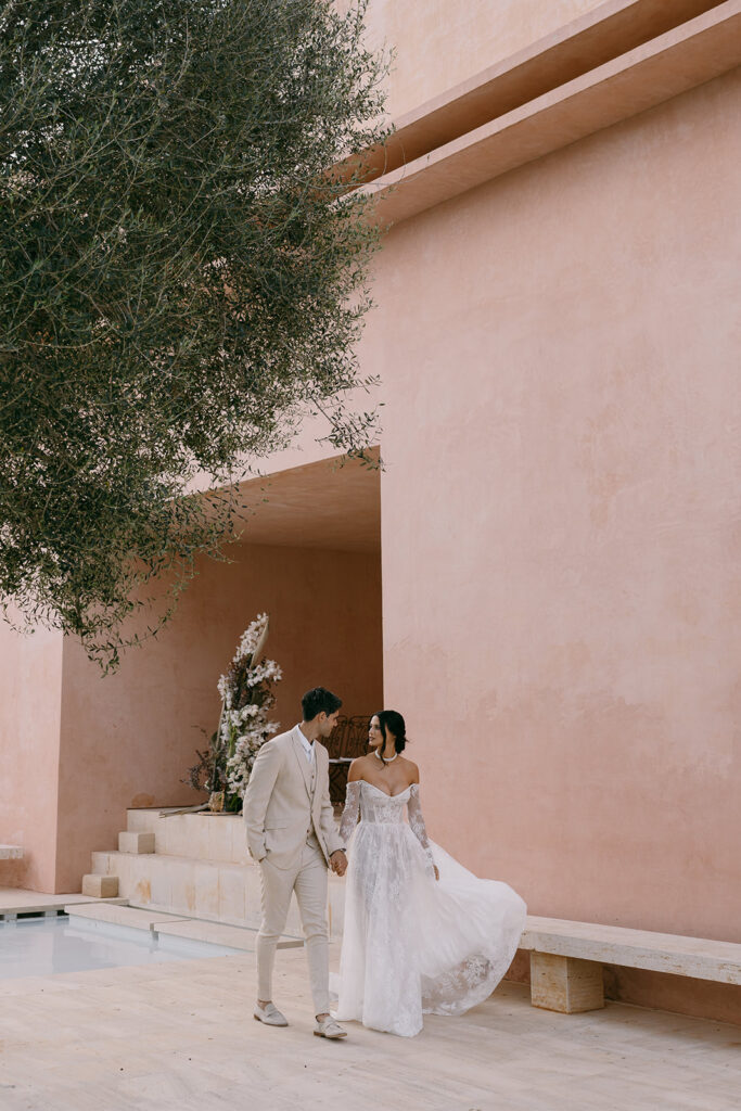 bride and groom with bride wearing a dreamy lace wedding gown with a long train