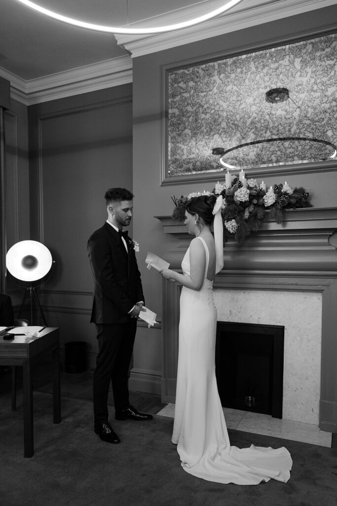 bride and groom reading vows