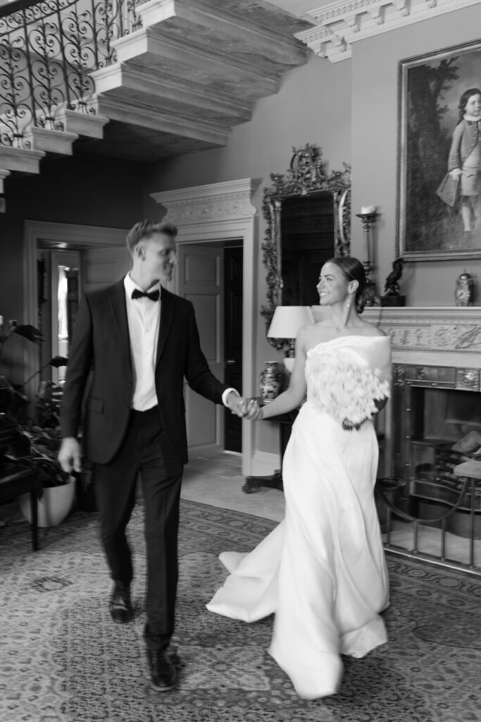 black and white photo of groom and bride - simple and beautiful off-the-shoulder dress