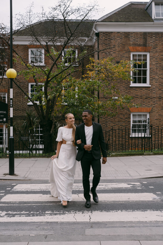 Bride and groom crossing the street together for an editorial styled shoot in London city